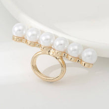 Load image into Gallery viewer, Gold ring with pearls on a light background